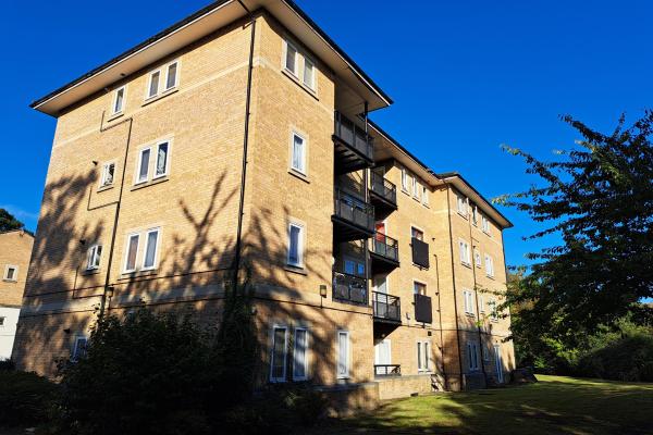 A yellow-brick 4-storey block of flats