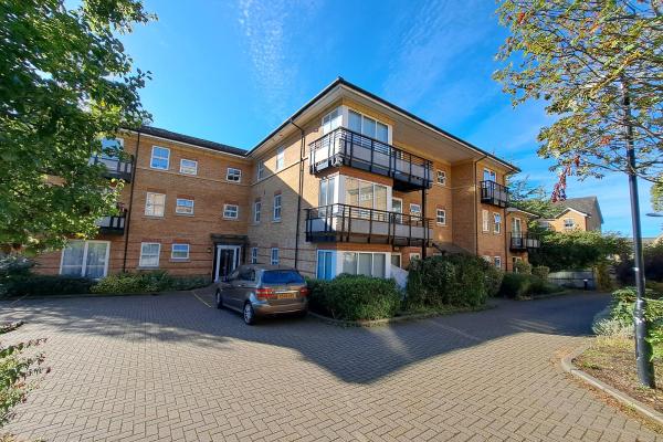 A modern 3-storey block of flats with balconies